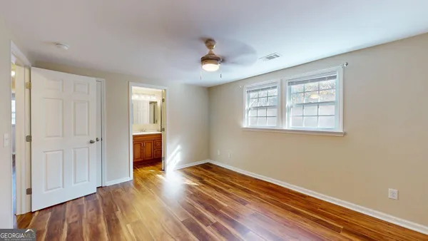 wooden floor in an empty room with a window