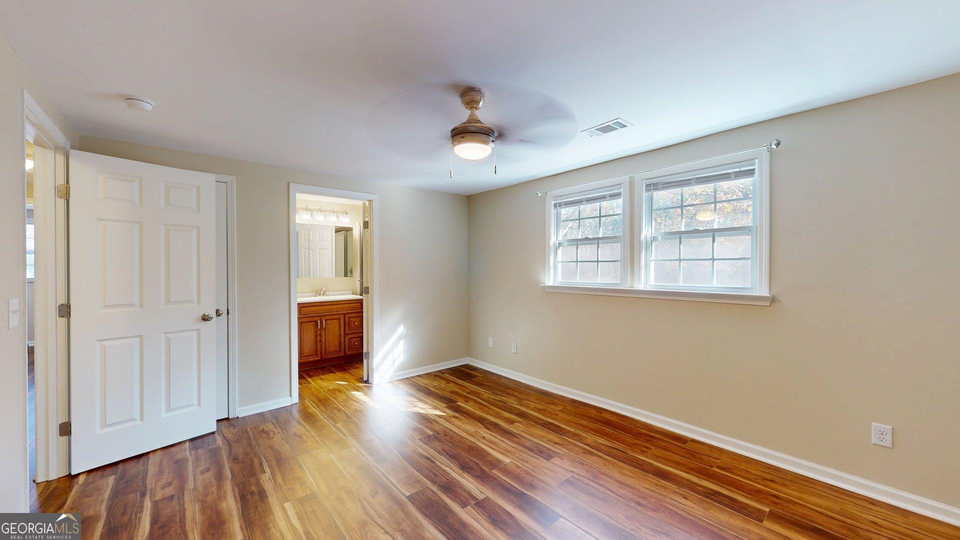 142 Bill Brown Road Pembroke, GA 31321 - Photo 16 of 33 a view of an empty room with wooden floor and a window