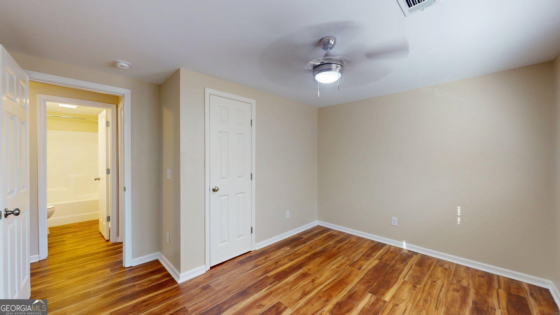 142 Bill Brown Road Pembroke, GA 31321 - Photo 17 of 33 wooden floor in an empty room with a window