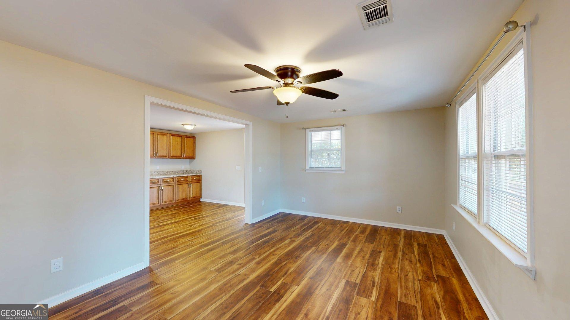 142 Bill Brown Road Pembroke, GA 31321 - Photo 5 of 33 wooden floor in an empty room with a window