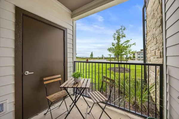 a view of balcony with furniture