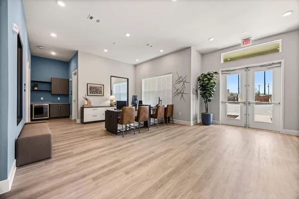 a large bedroom with furniture and large window