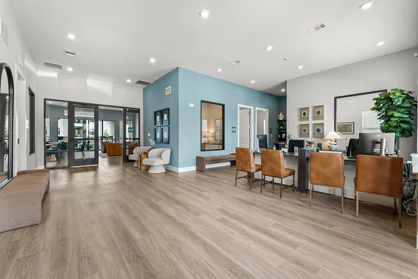 a living room with furniture and a wooden floor