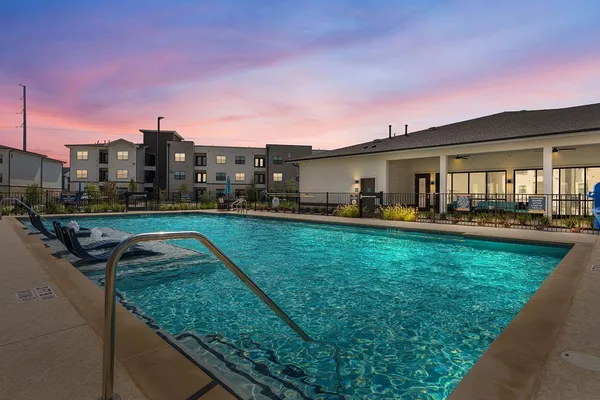 a swimming pool with outdoor seating and yard