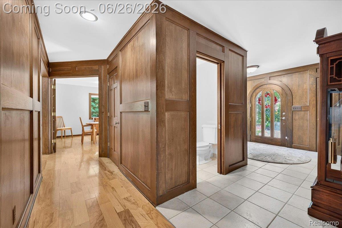 29498 East River Road Grosse Ile, MI 48138 - Photo 7 of 66 First Floor Hallway with Wood Paneled Walls and Floors