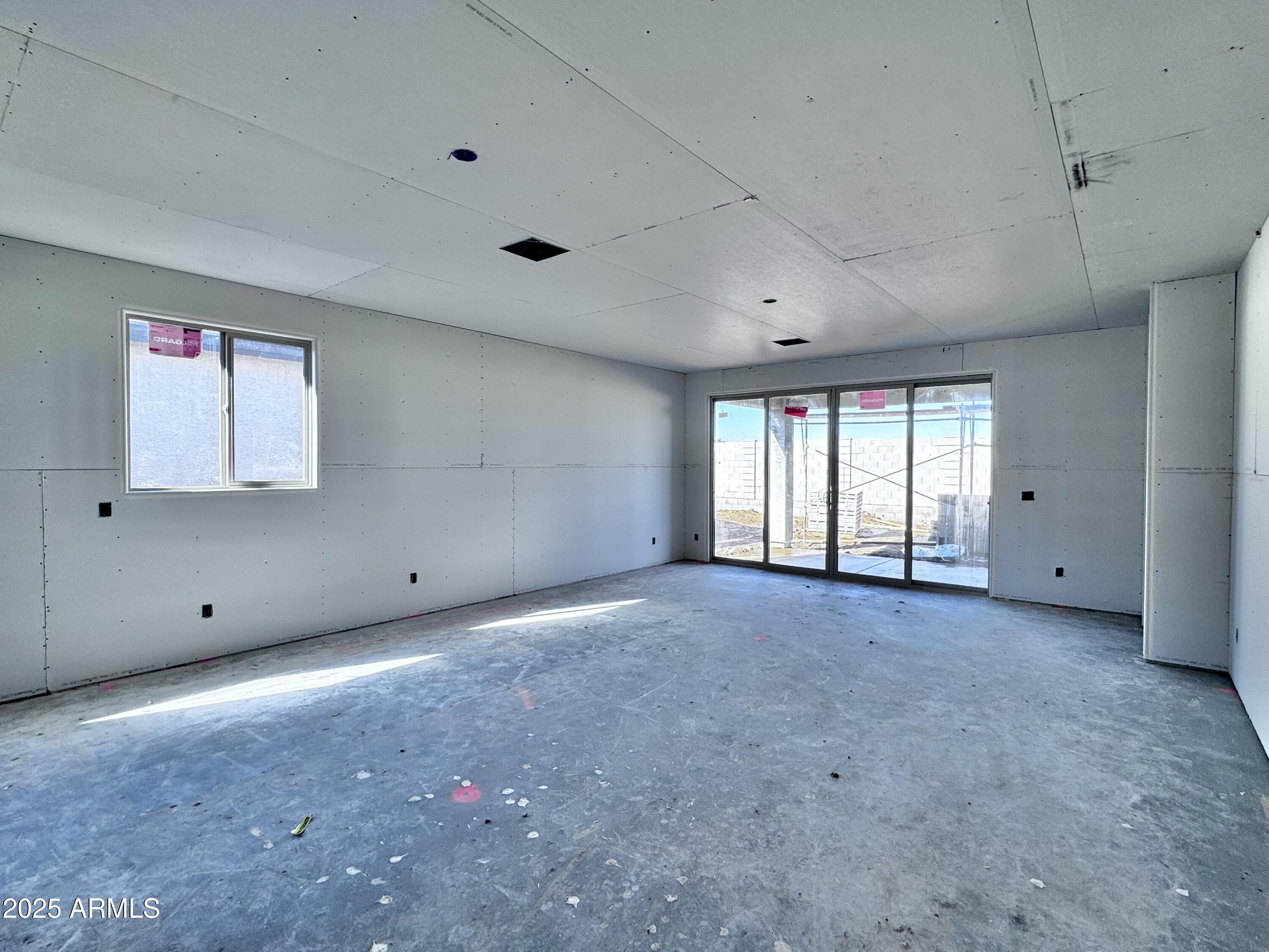 15716 West Camden Avenue Waddell, AZ 85355 - Photo 5 of 24 a view of an empty room with a window