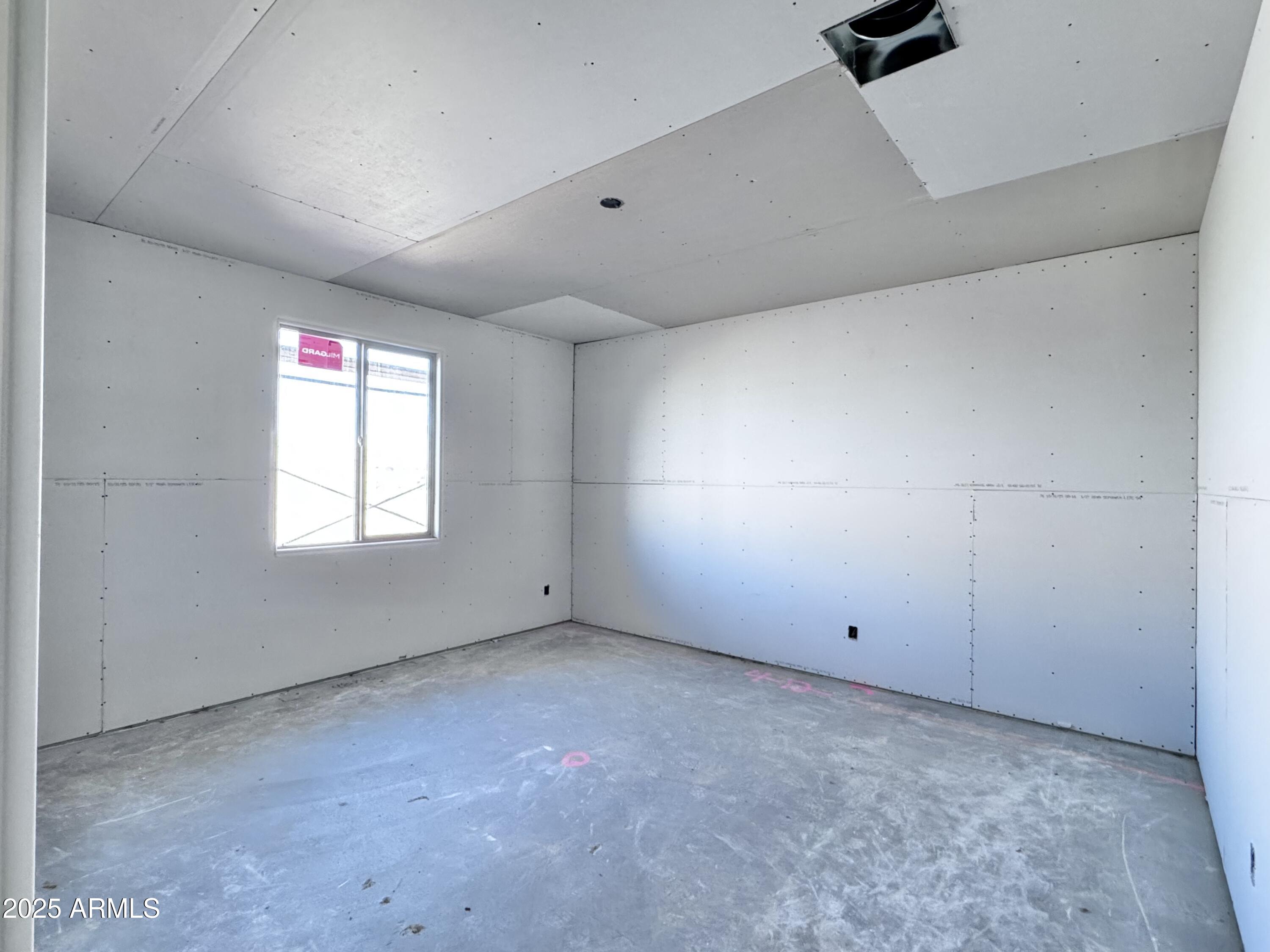 15716 West Camden Avenue Waddell, AZ 85355 - Photo 6 of 24 an empty room with ceiling fan and window