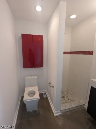 a bathroom with a toilet and a shower