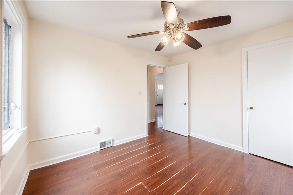 3958 Monroeville Boulevard Monroeville, PA 15146 - Photo 14 of 29 an empty room with wooden floor fan and windows