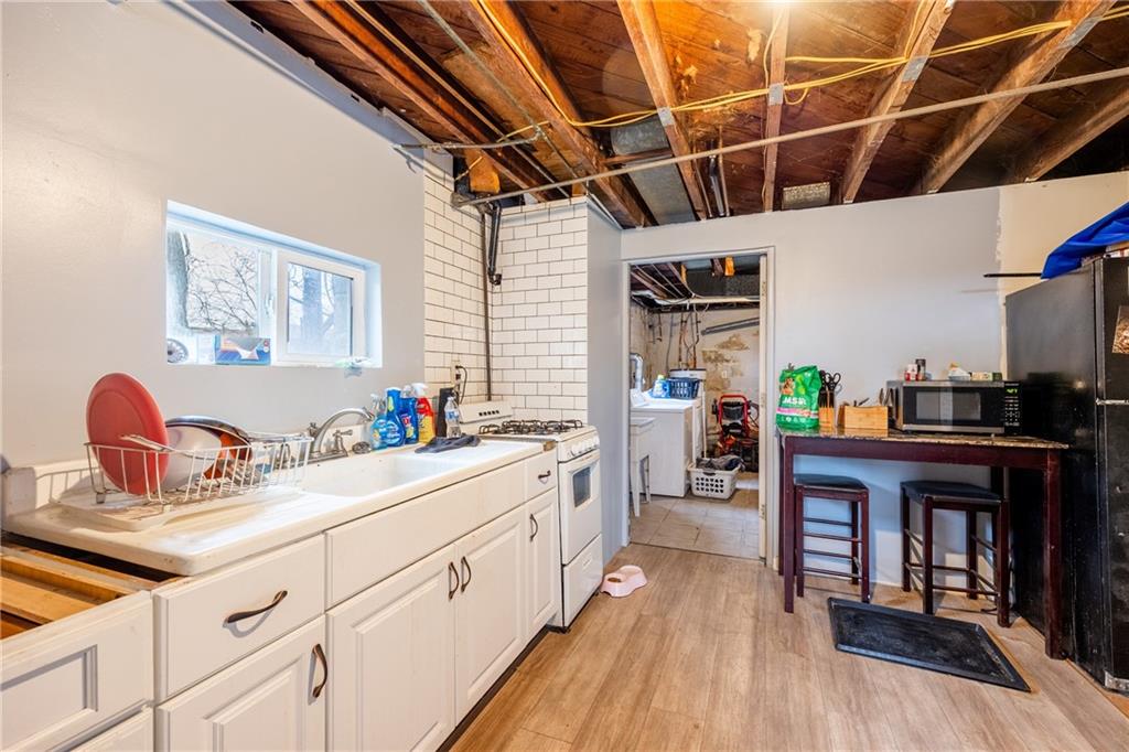 3958 Monroeville Boulevard Monroeville, PA 15146 - Photo 18 of 29 a kitchen with a sink cabinets and wooden floor