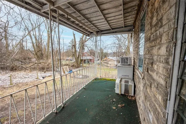 a view of a porch with wooden floor and roof