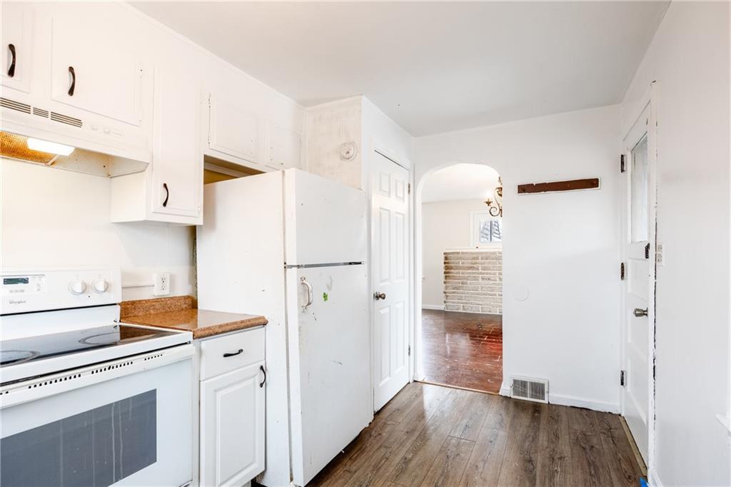 3958 Monroeville Boulevard Monroeville, PA 15146 - Photo 9 of 29 a kitchen with a refrigerator a stove and wooden floor