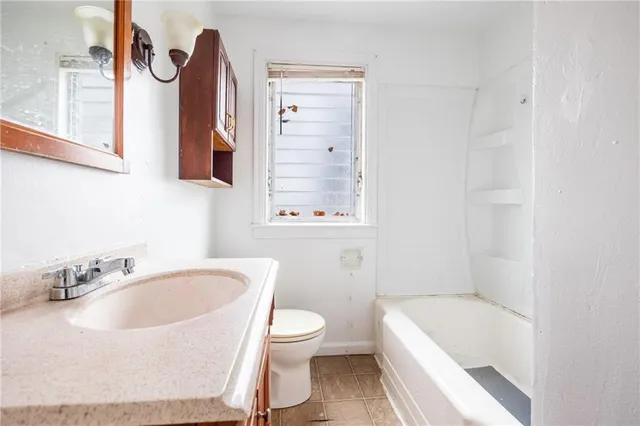 a bathroom with a sink a toilet and bathtub