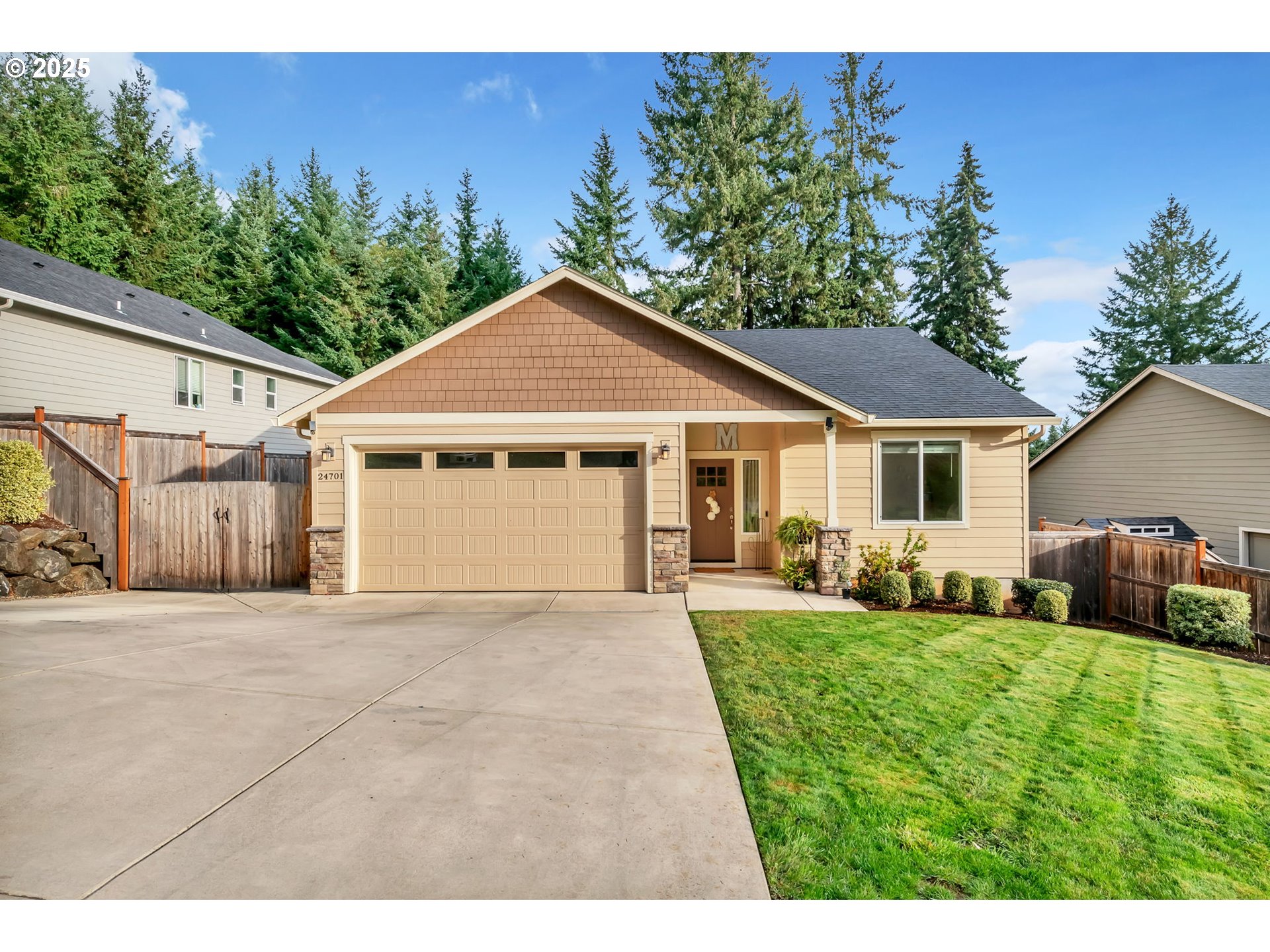 a front view of a house with a yard and trees
