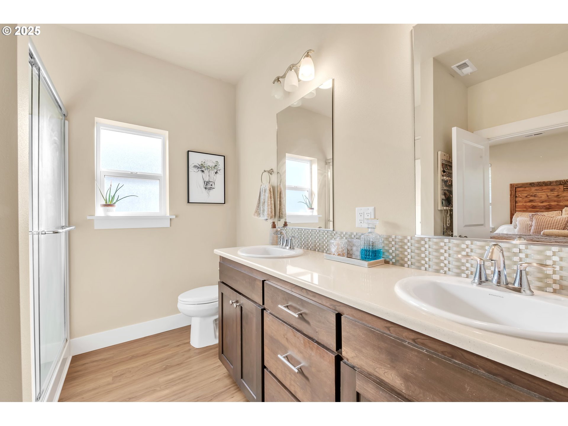 24701 Nottingham Street Veneta, OR 97487 - Photo 12 of 28 a bathroom with a granite countertop sink mirror vanity and a toilet