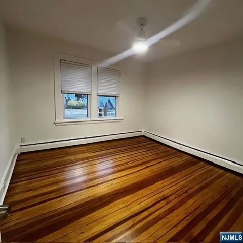 a view of a room with wooden floor and window