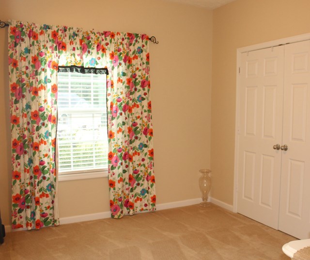 313 Hickory Road Jackson, GA 30233 - Photo 12 of 17 an empty room with a window and a small yard