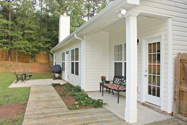 313 Hickory Road Jackson, GA 30233 - Photo 15 of 17 a front view of a house with a garden and plants