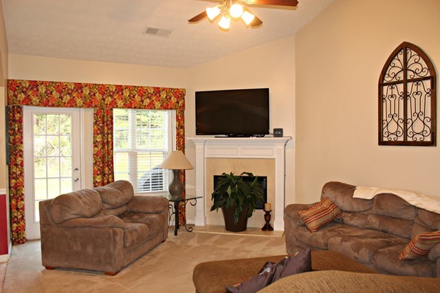 313 Hickory Road Jackson, GA 30233 - Photo 3 of 17 a living room with furniture a fireplace and a flat screen tv