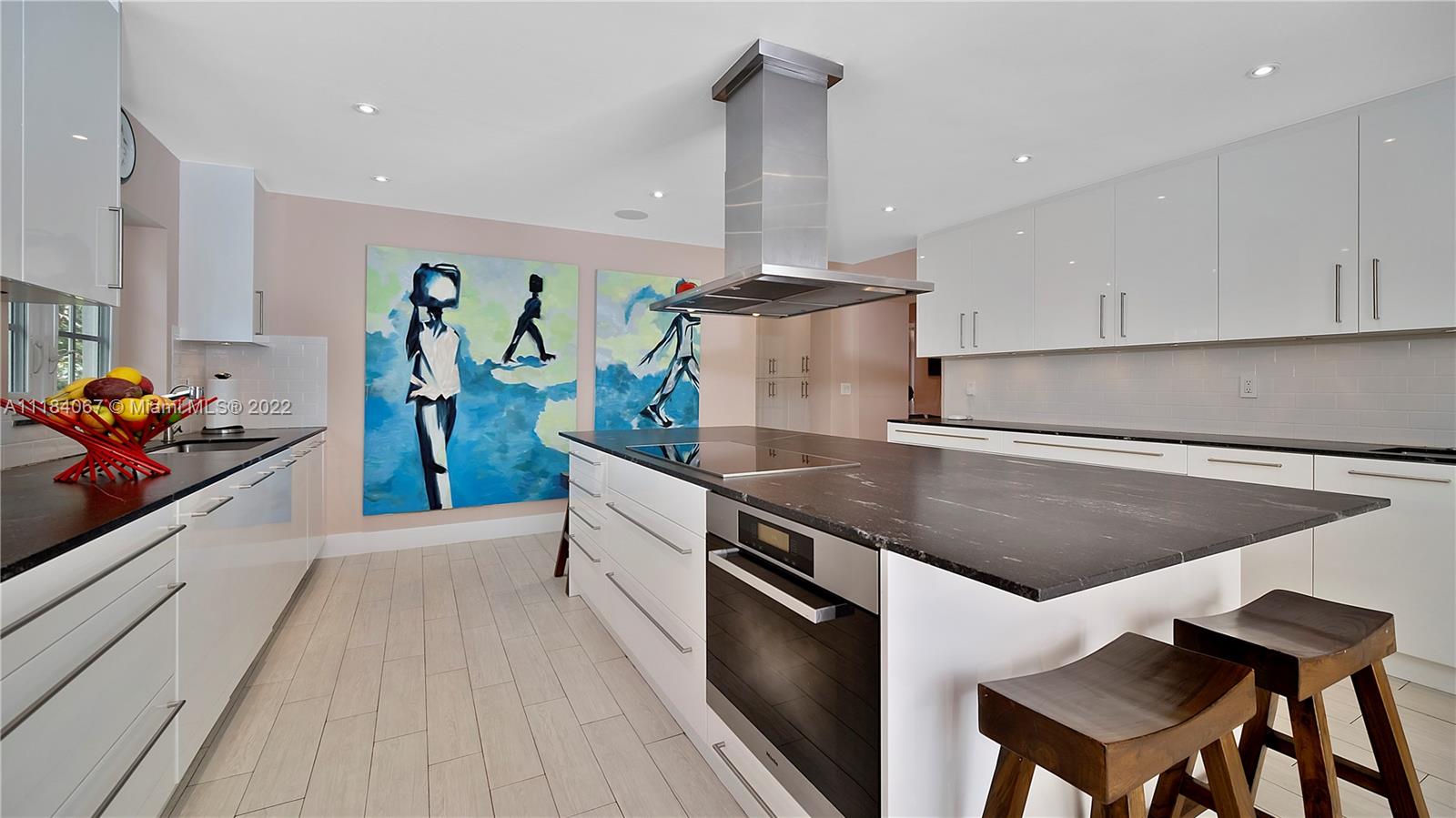 1136 Alhambra Circle Coral Gables, FL 33134 - Photo 11 of 67 a kitchen with stainless steel appliances granite countertop a sink a stove and a wooden floors