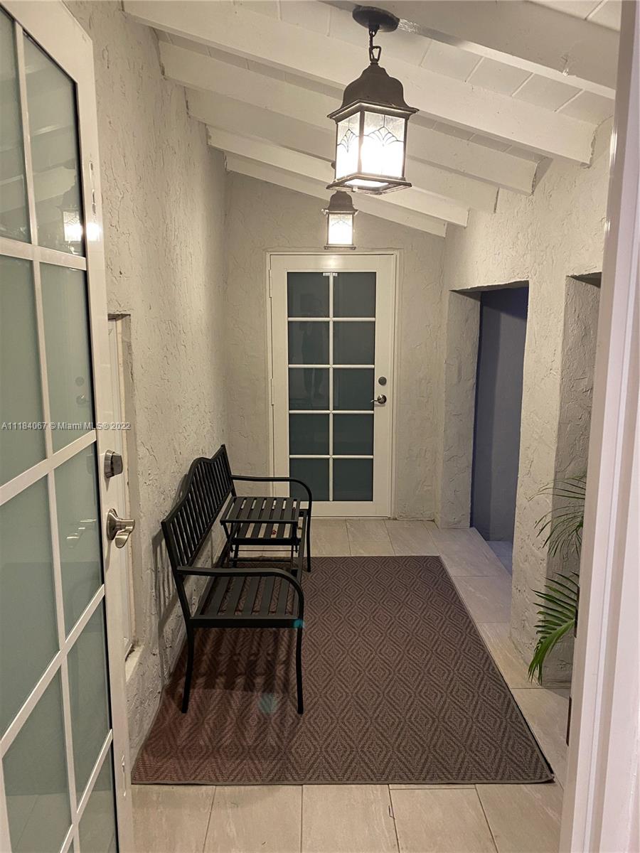 1136 Alhambra Circle Coral Gables, FL 33134 - Photo 17 of 67 a living room with furniture and a window