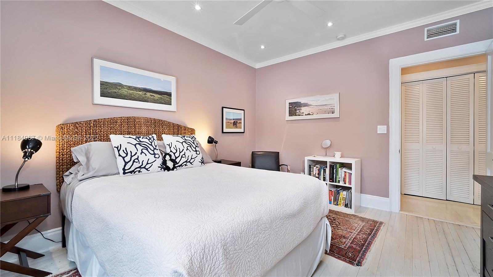 1136 Alhambra Circle Coral Gables, FL 33134 - Photo 44 of 67 a bedroom with a bed and a table