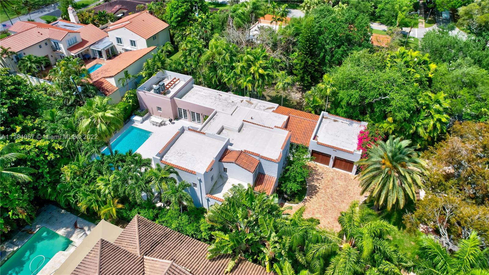 1136 Alhambra Circle Coral Gables, FL 33134 - Photo 64 of 67 an aerial view of residential house with outdoor space and trees all around