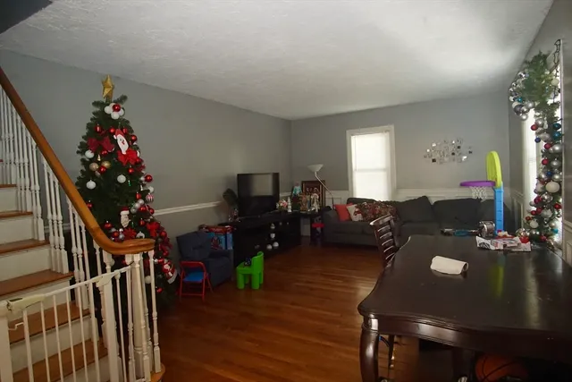 a living room with furniture flowers and a chandelier