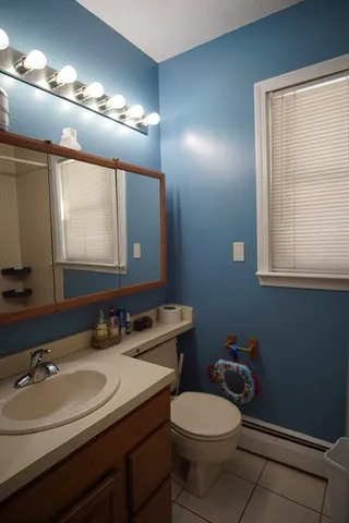 a bathroom with a sink toilet and mirror