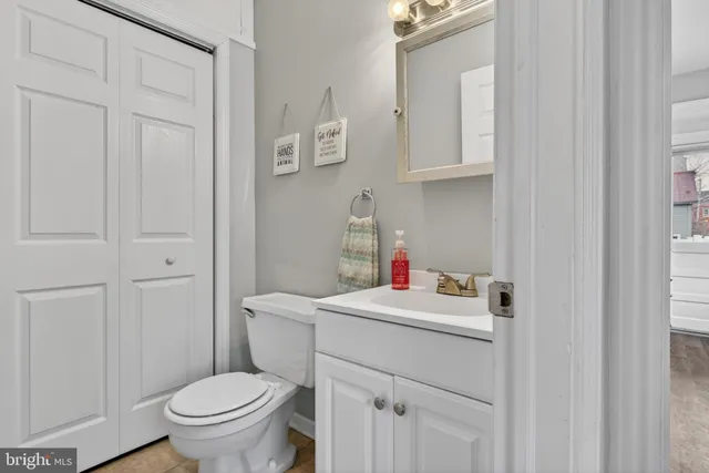 a bathroom with a sink toilet and a mirror