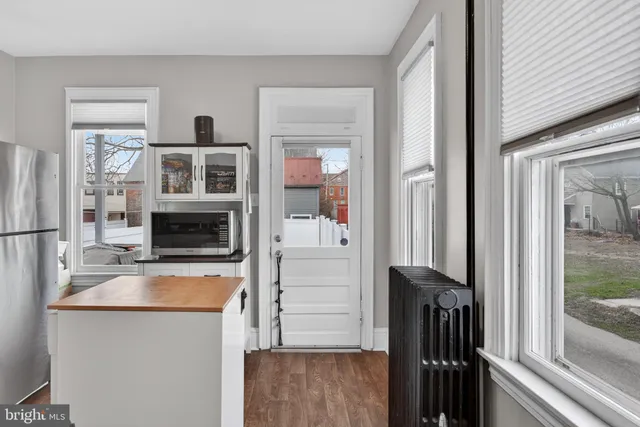 a kitchen with a refrigerator and a stove top oven