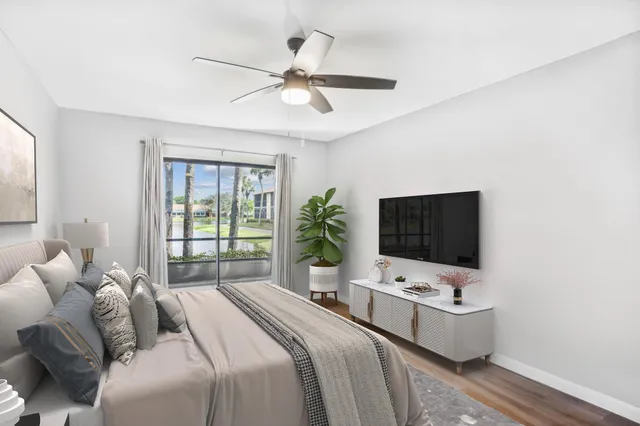 a bedroom with a bed tv and a window