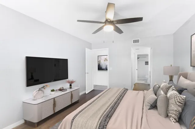 a bedroom with a bed and a flat screen tv