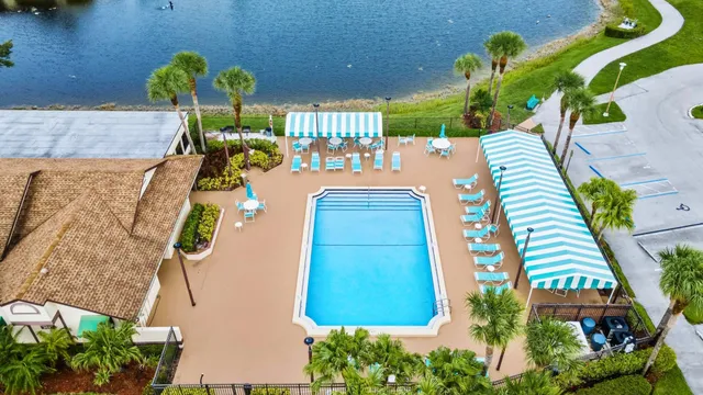 a view of a swimming pool with a patio and a garden