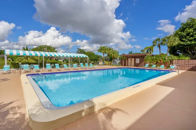 a view of a swimming pool and outdoor seating