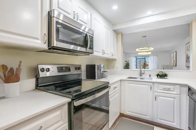 a kitchen with a stove microwave and sink