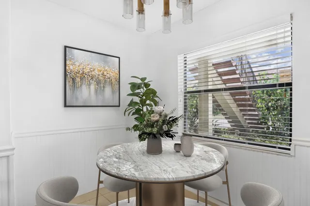 a dining room with furniture and window