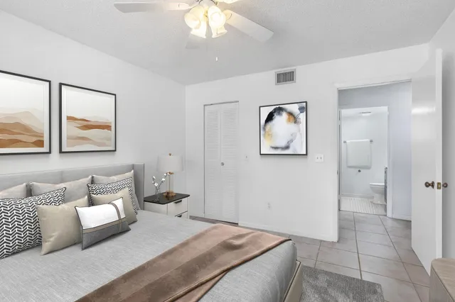 a bedroom with a bed and a painting on the wall