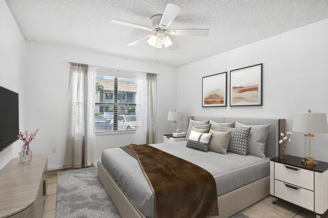 a bedroom with a large bed and a flat screen tv