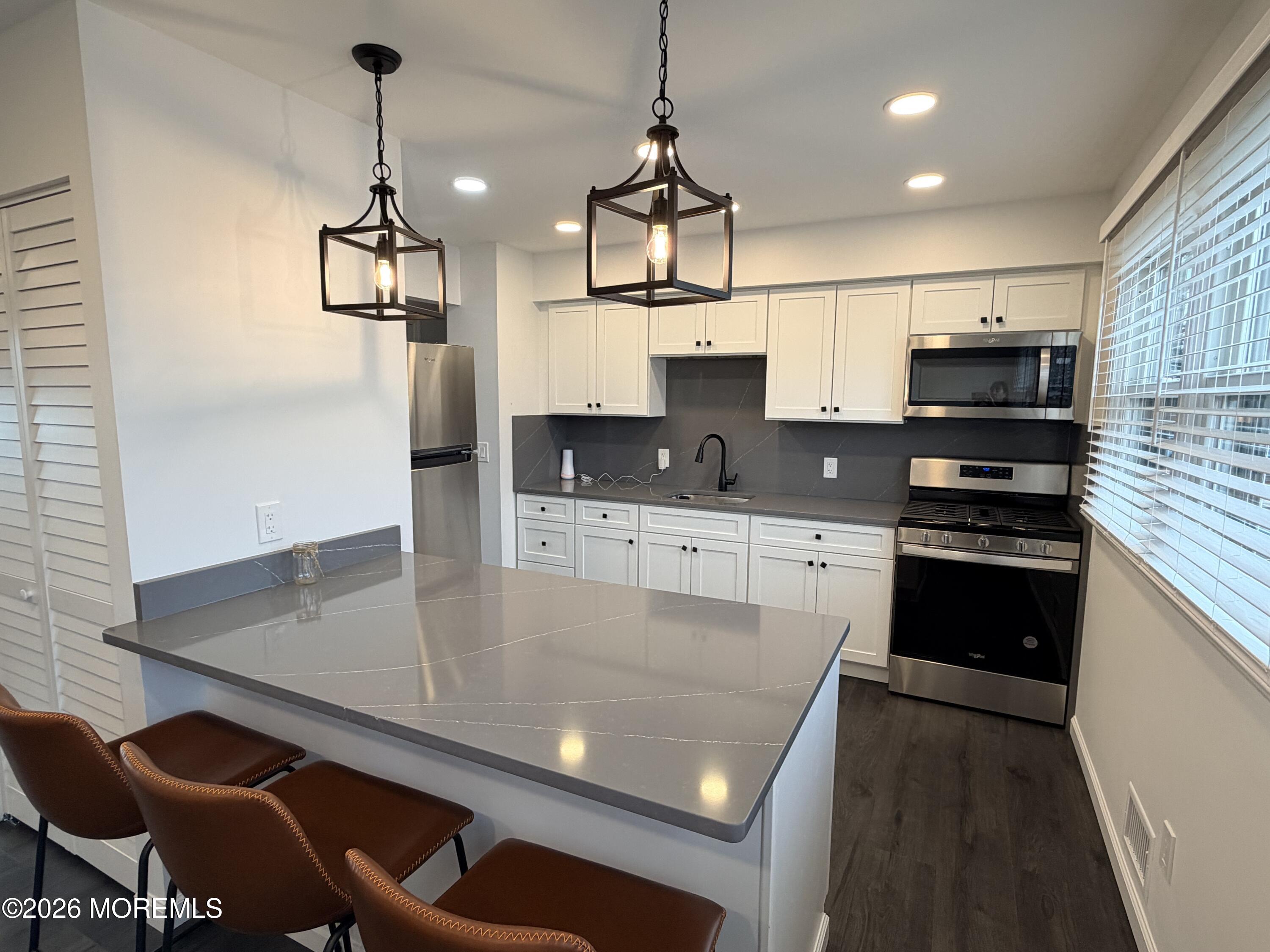 2133 Bridge Avenue Point Pleasant, NJ 08742 - Photo 1 of 12 a kitchen with kitchen island a counter space a sink and appliances