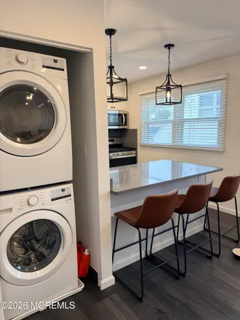 a view of a room with furniture and wooden floor
