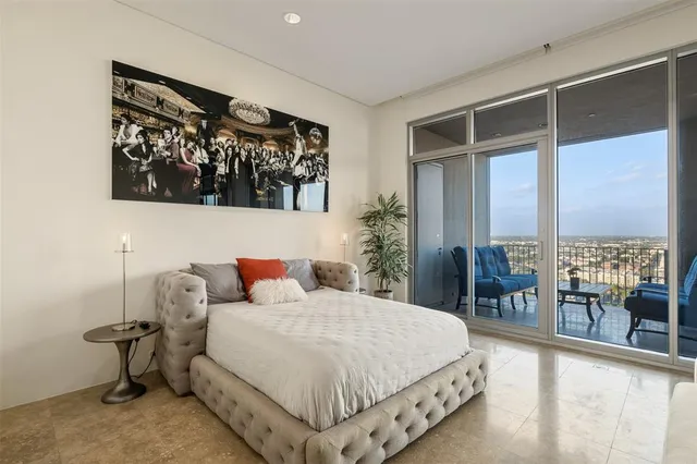 a bedroom with a large bed and a large window