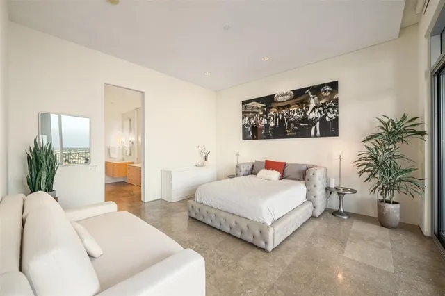 a bedroom with a bed and a couch