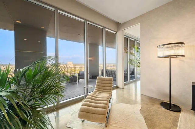 a lobby with furniture and potted plants