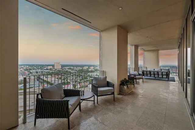 a living room with furniture and a floor to ceiling window