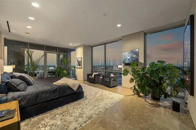 a large bedroom with furniture and large windows