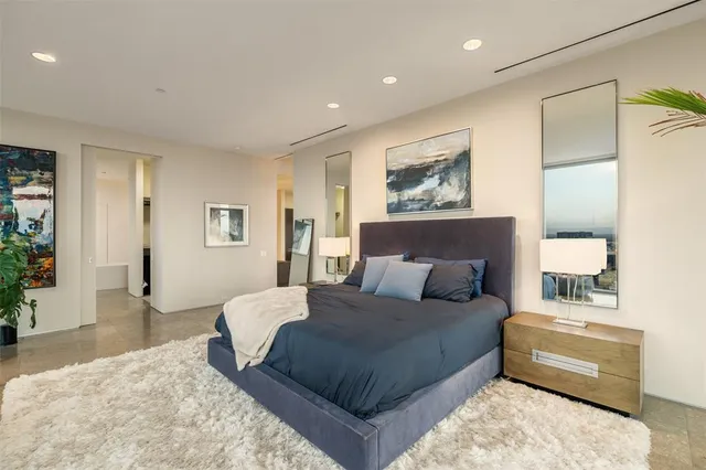 a bedroom with a large bed and a couch