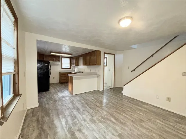 a view of a kitchen with a sink dishwasher refrigerator and cabinets