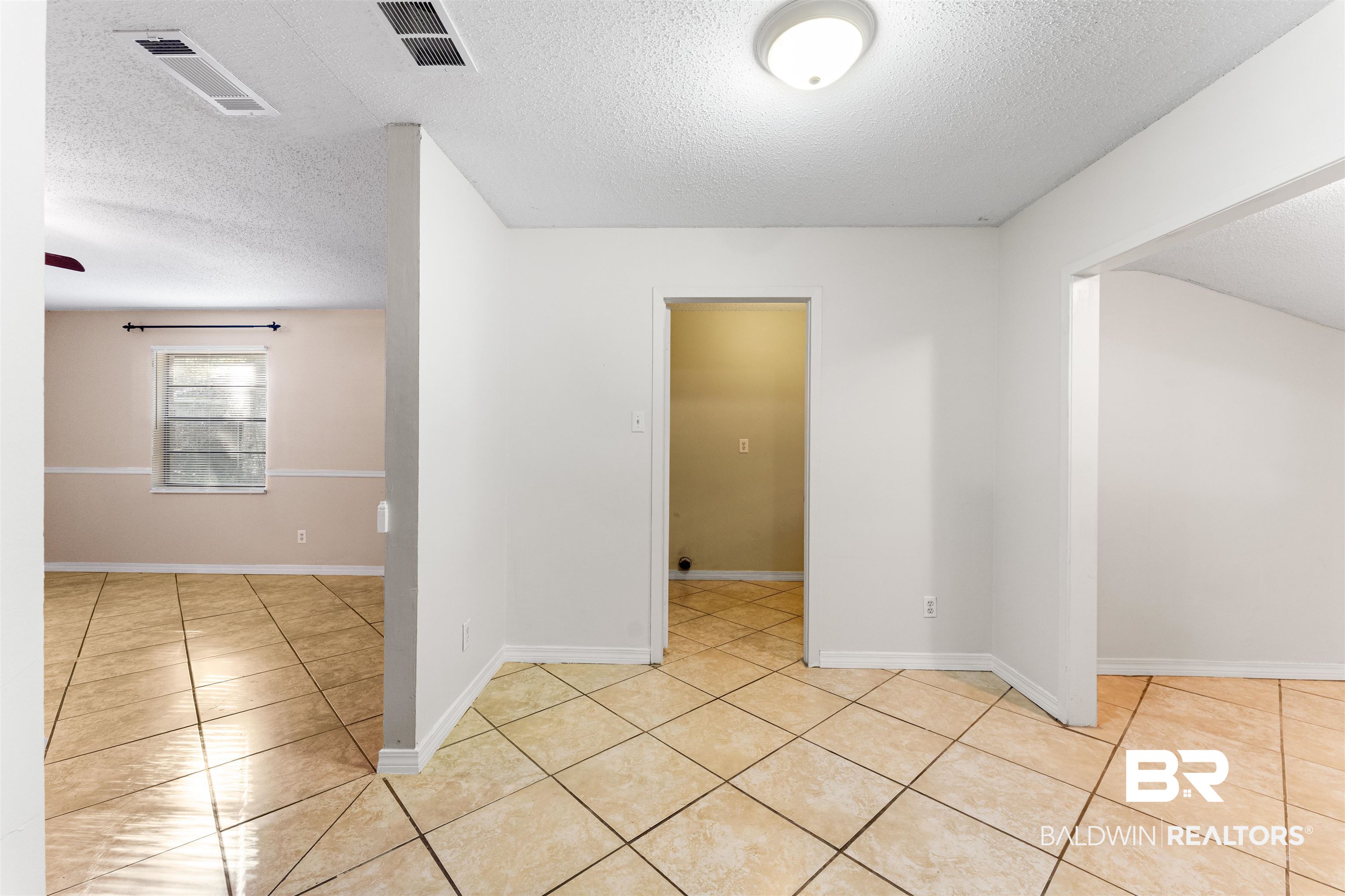 5551 Springer Court Theodore, AL 36582 - Photo 21 of 37 Unfurnished room with a textured ceiling and light tile patterned floors