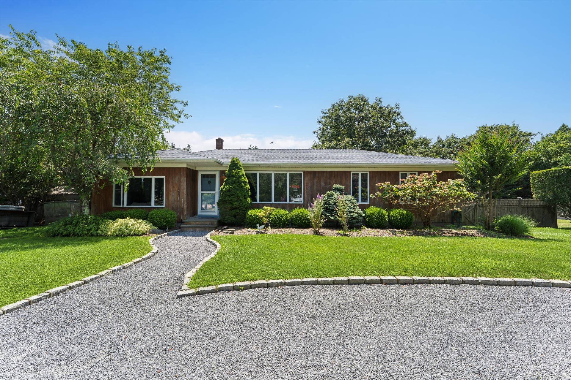 27 South Country Road Westhampton, NY 11977 - Photo 16 of 16 a front view of a house with a yard and porch